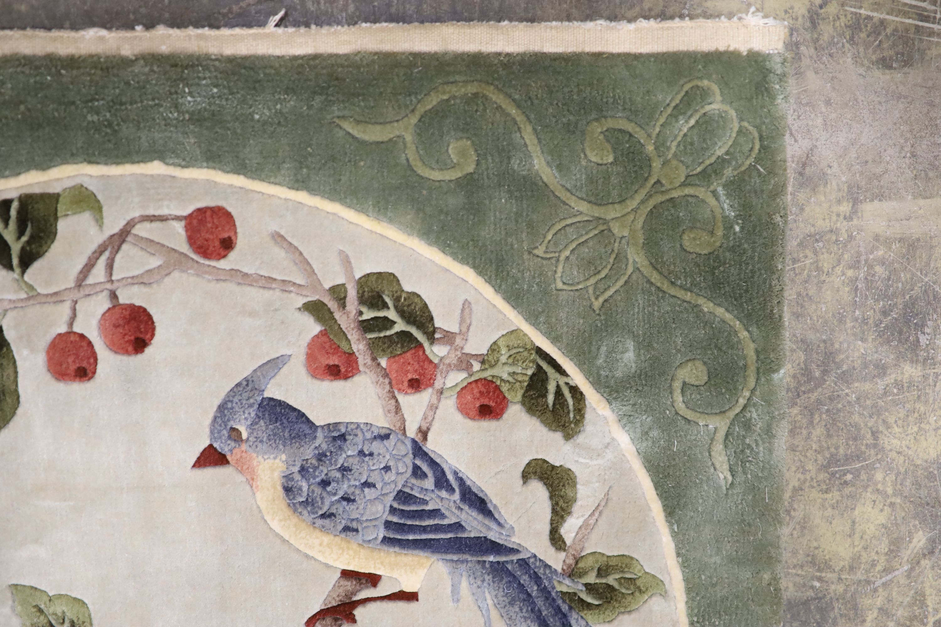 A Chinese washed and embossed panel depicting birds amongst prunus and cherries